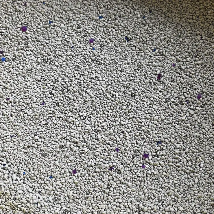 Little blue mineral bentonite cat litter with blue mineral particles purple mineral particles and carbon balls